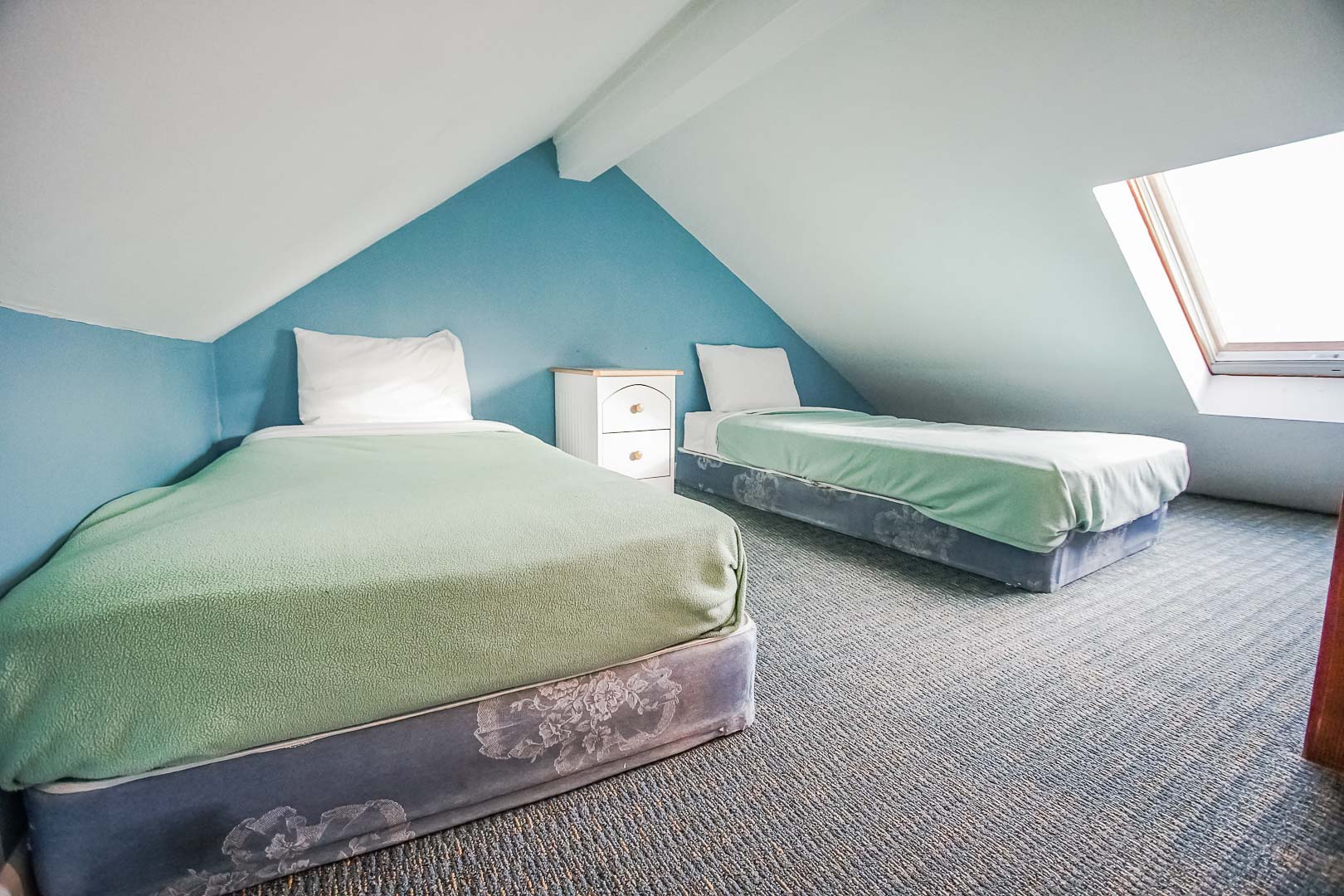 A loft bedroom with double beds at VRI's Seawinds II Resort in Massachusetts.